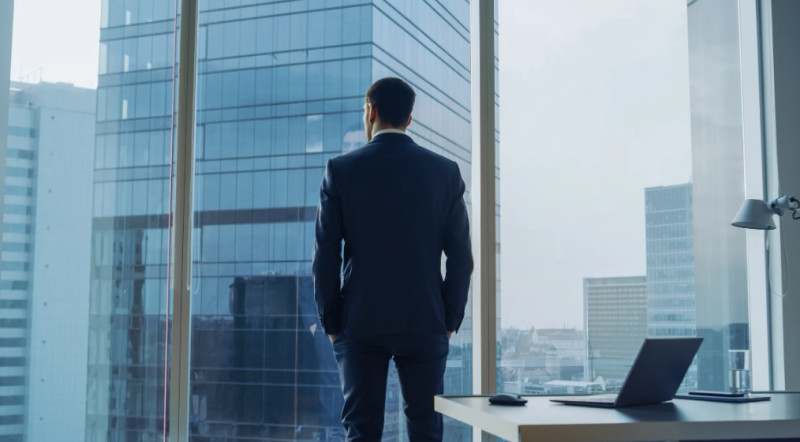 Investor Looking Out from an Office